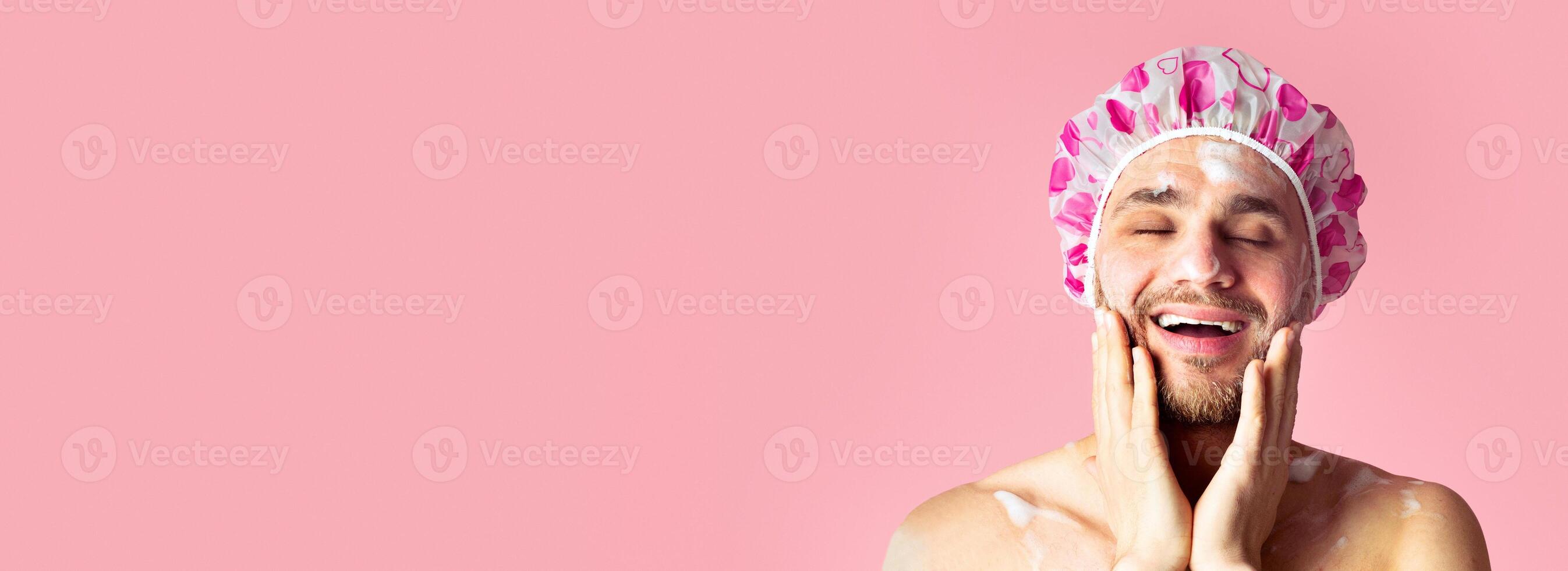 Funny guy in shower cap washing his face, free space photo