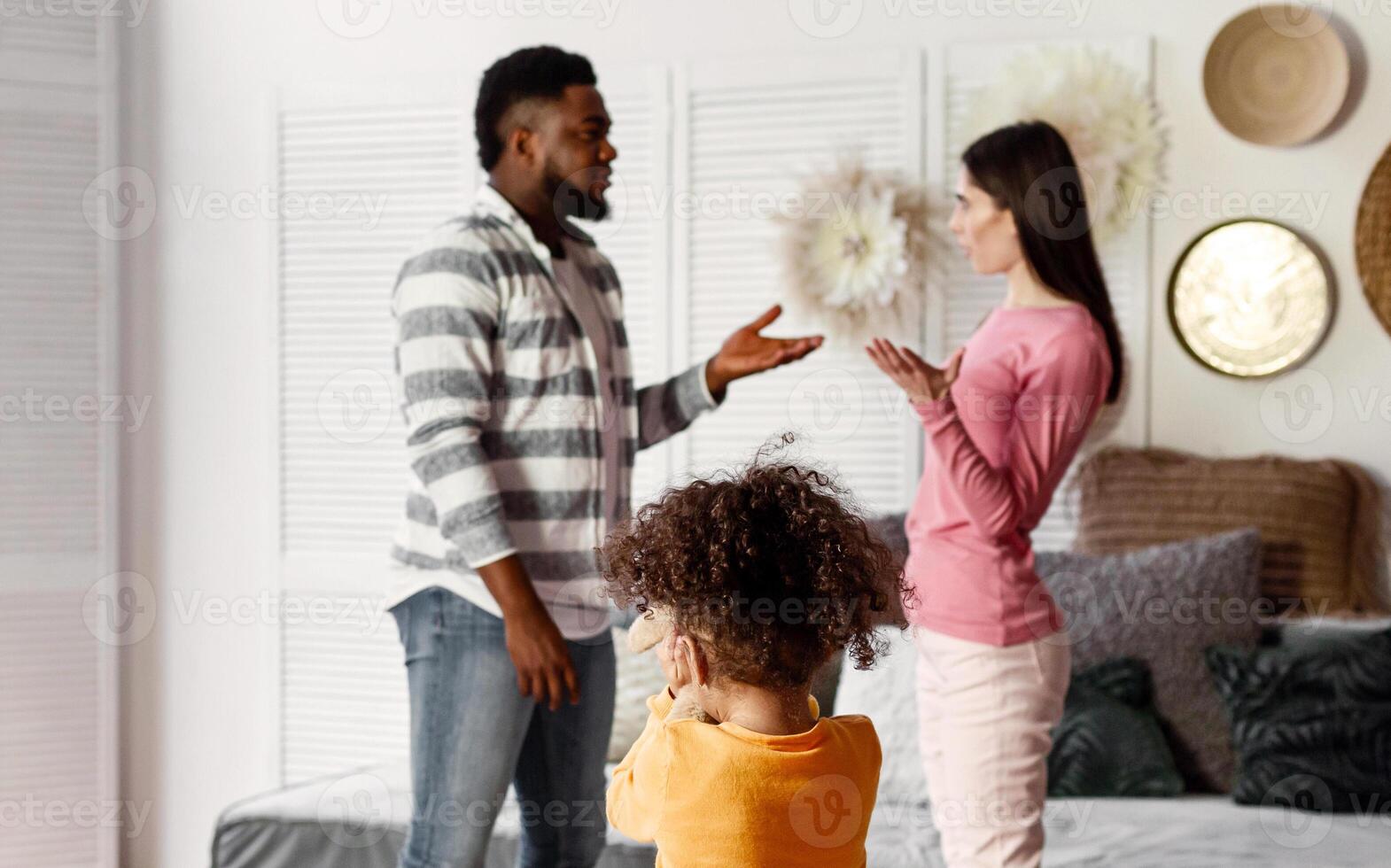 Daughter covers her ears when parents quarrel at home photo