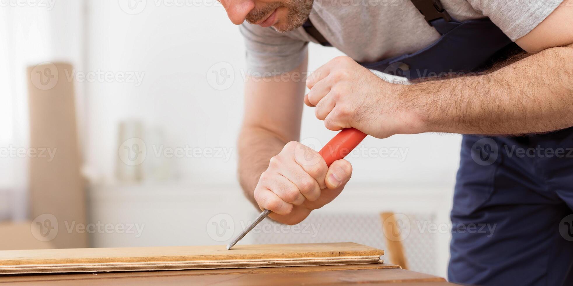 Carpenter Making Furniture Working With Wooden Board Indoor, Wearing Blue Coverall. Selective Focus, Empty Space photo