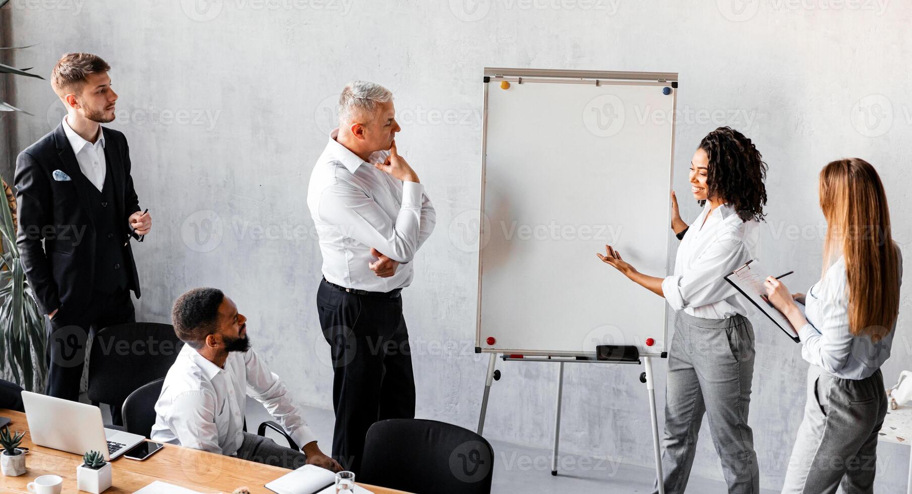Corporate Meeting. Black Businesswoman Presenting Business Idea To Colleagues Brainstorming Startup Project In Modern Office. photo