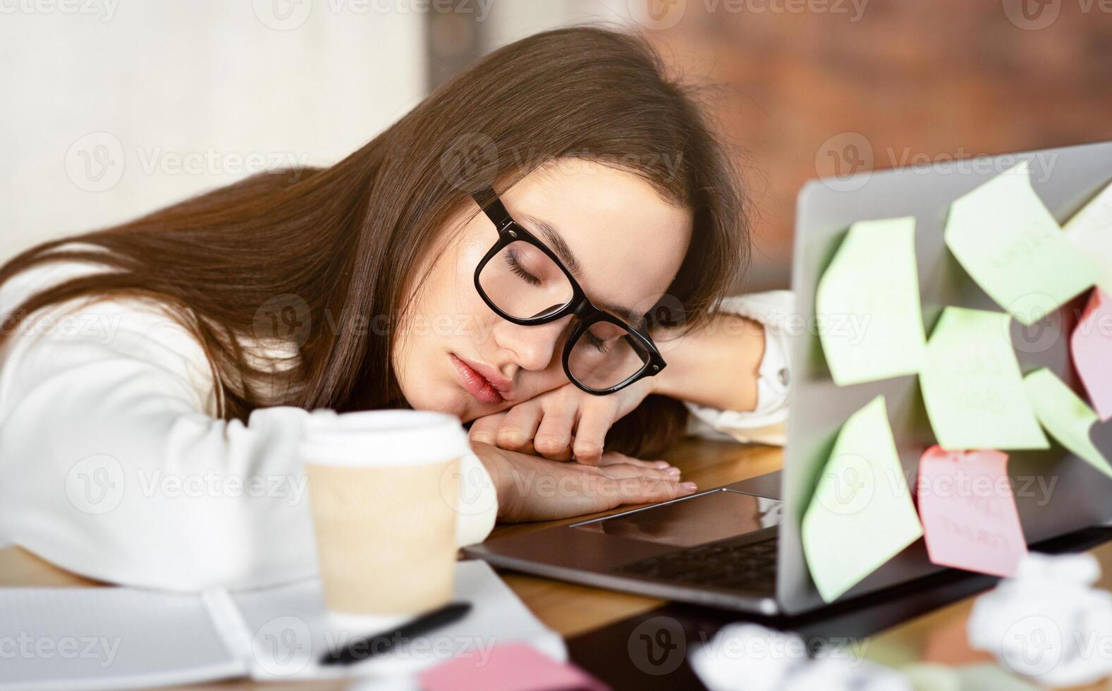 Overwork concept. Freelance girl sleeping on laptop, free space photo