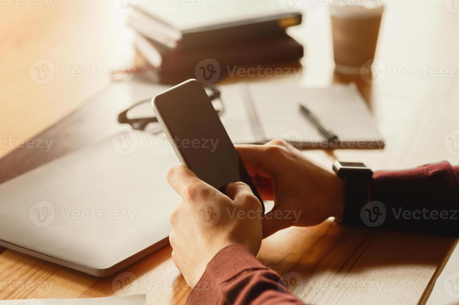 Phone User. Unrecognizable Man Texting On Cellphone Sitting At Workplace Indoor. Cropped, Selective Focus photo