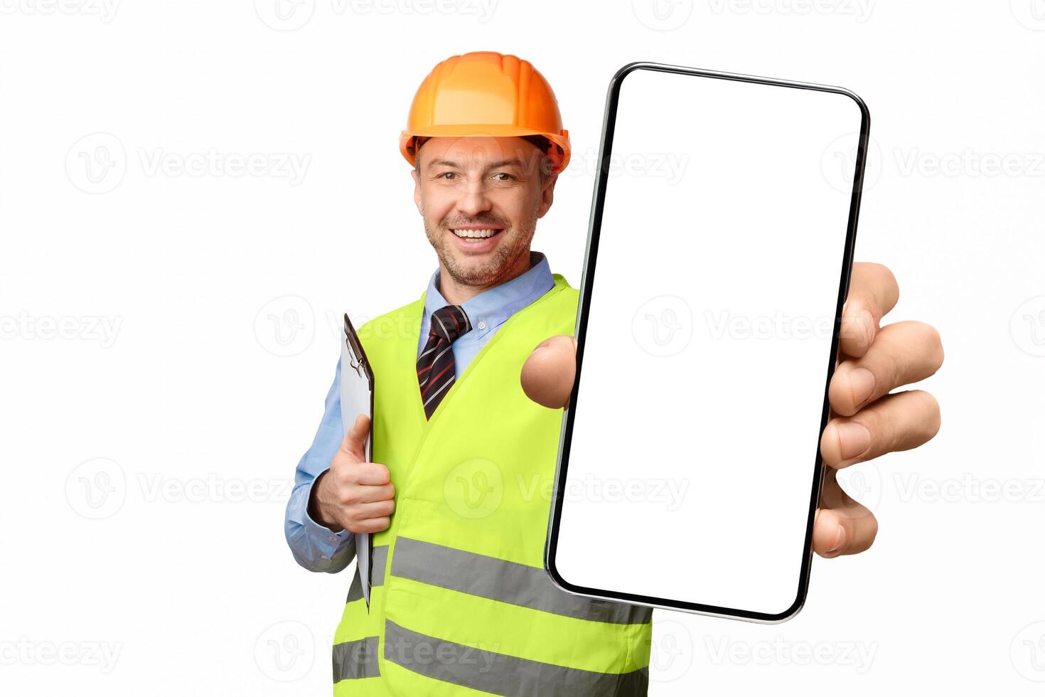 Happy Builder Pointing Pencil At Camera Holding Folder Standing On White Studio Background. Building Career And Employment. photo