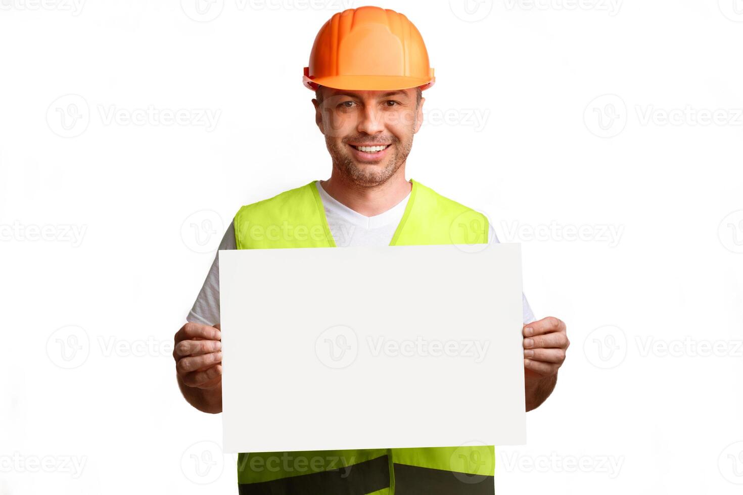 Construction Worker Showing Empty Poster Board Advertising Your Text Posing Standing On White Background In Studio, Smiling To Camera. Professional Builder's Service Advert. Mockup photo
