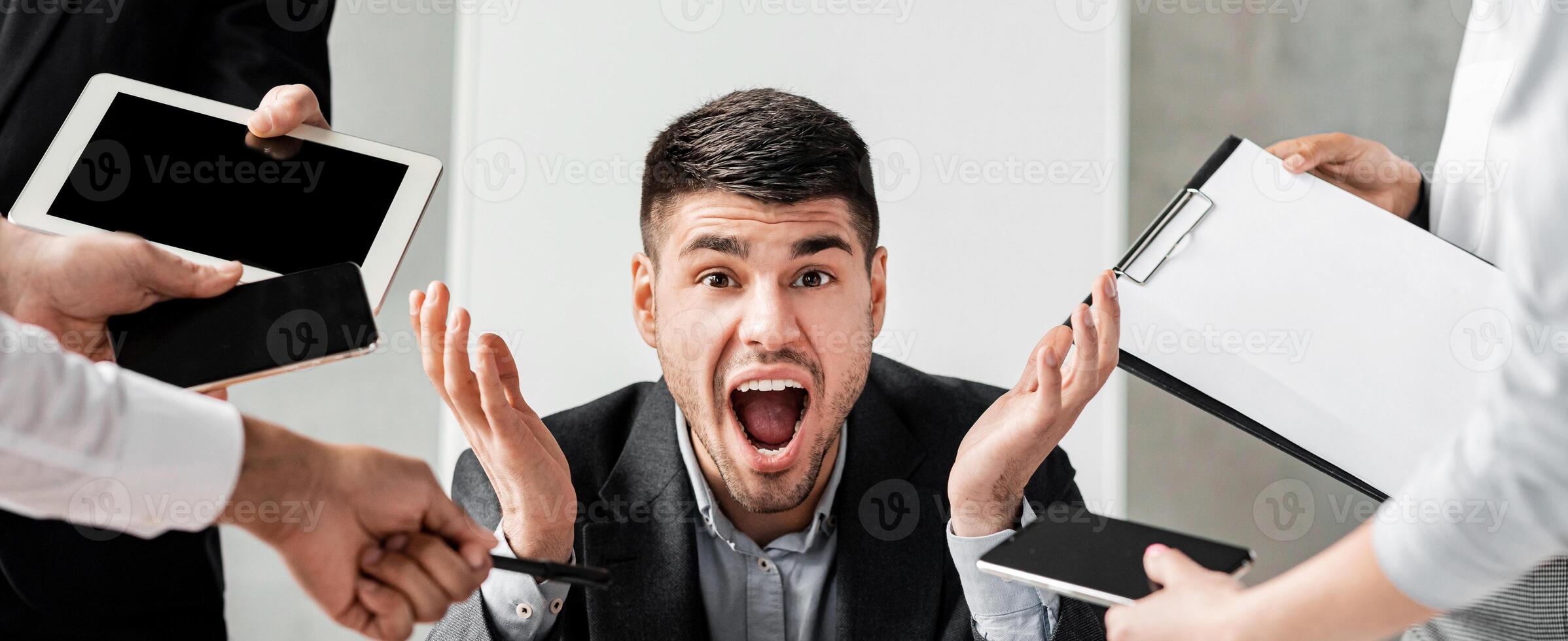 Multitasking And Deadline. Businessman Shouting Stressed By Multiple Work Tasks Sitting At Laptop In Modern Office. photo