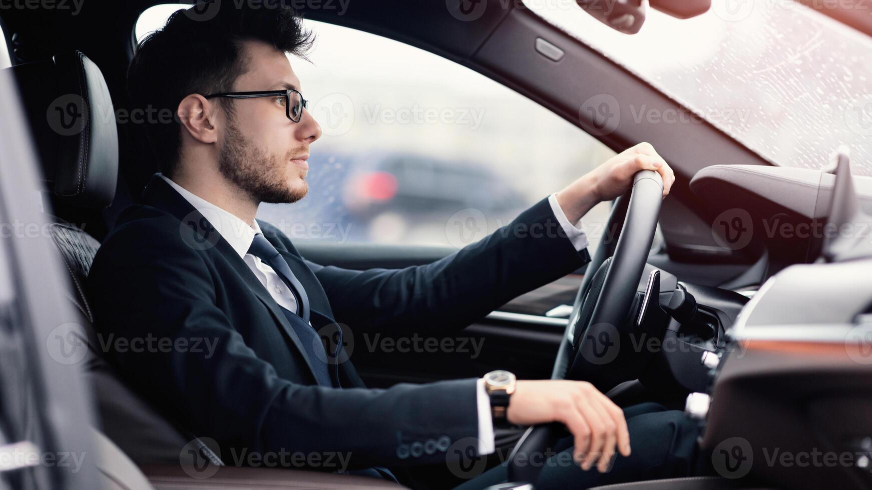 Going To Work Place. Adult bearded business man driving car, holding hand on gear shift, free space photo