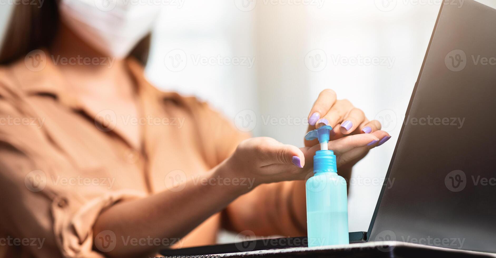 Close up of female hands using wash hand sanitizer gel pump dispenser, killing germs, bacteria and virus, panorama, copyspace photo