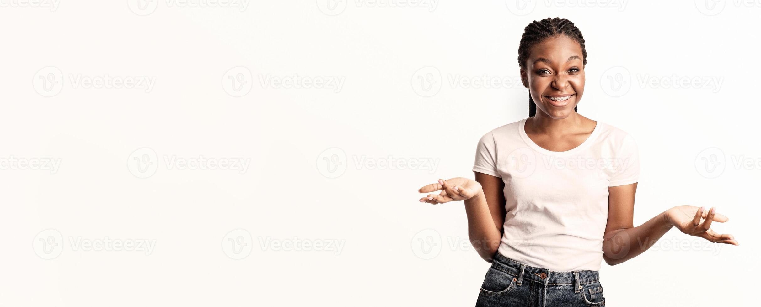 Cheerful African American Woman Telling Something To Camera Gesturing With Hands Posing On White Background. Studio Shot photo