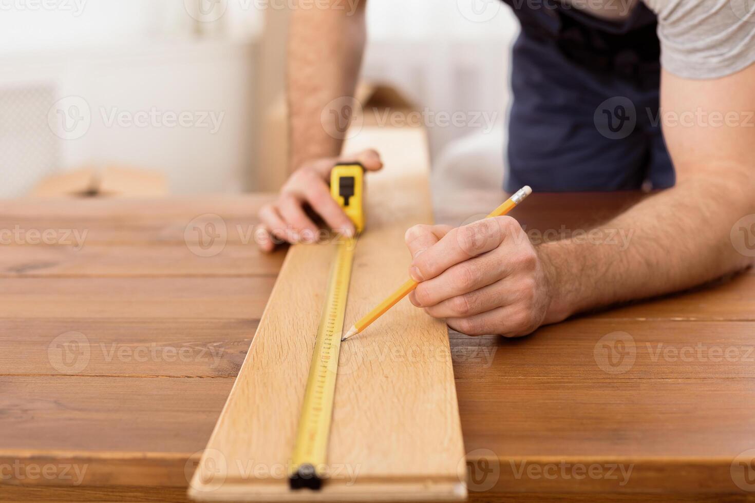 Carpentry Career Concept. Unrecognizable Carpenter Measuring Wooden Board Making A Piece Of Furniture Working In His Studio. Cropped Shot, Selective Focus photo