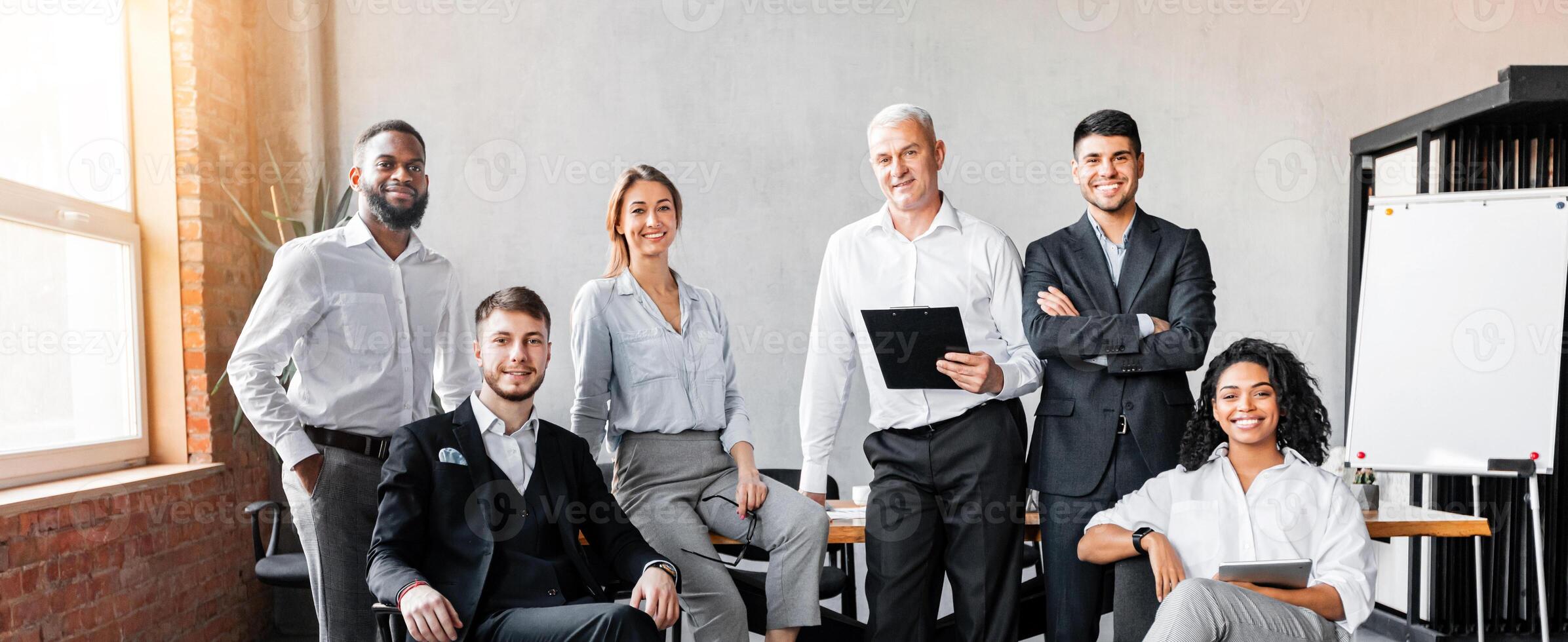 Successful Business Team. Coworkers Smiling To Camera Posing At Workplace In Modern Office. Full Length photo