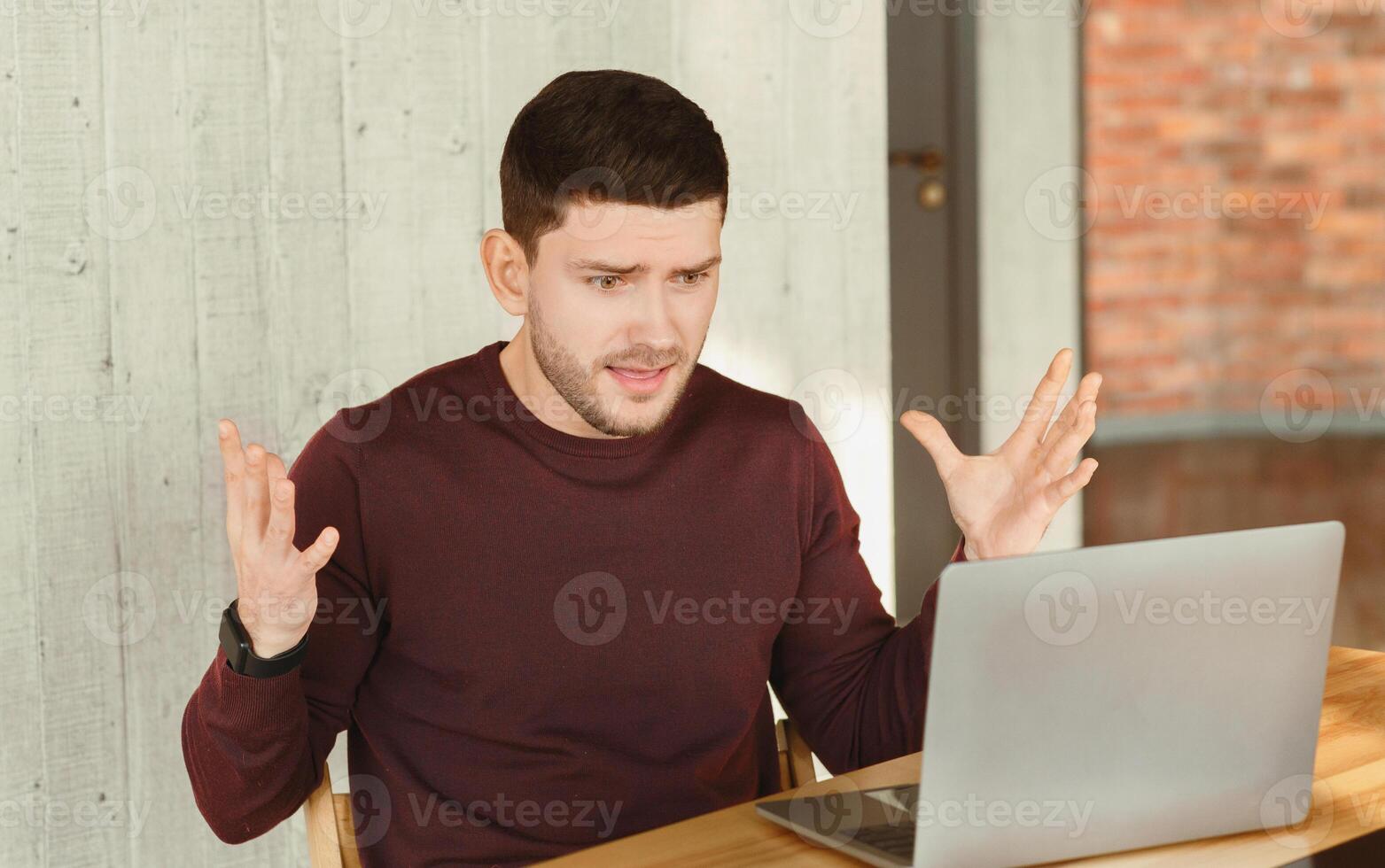 Computer Problem. Unhappy Man At Laptop Gesturing With Hands Having Issue At Work In Modern Office. Selective Focus photo