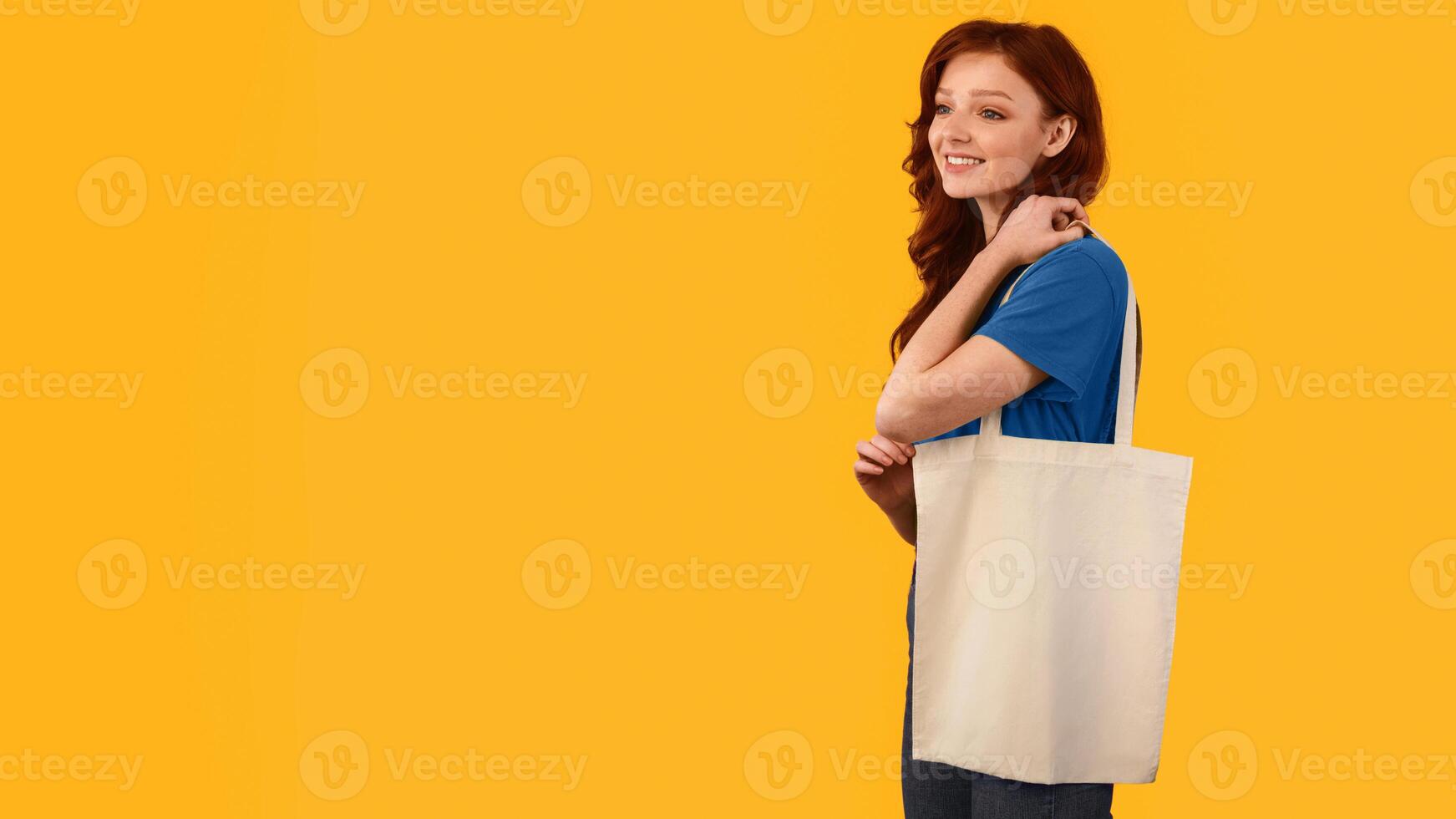 Girl With Flax Eco Shopper Bag Posing In Studio Over Yellow Background. No Plastic, Ecology Concept. Panorama With Empty Space photo