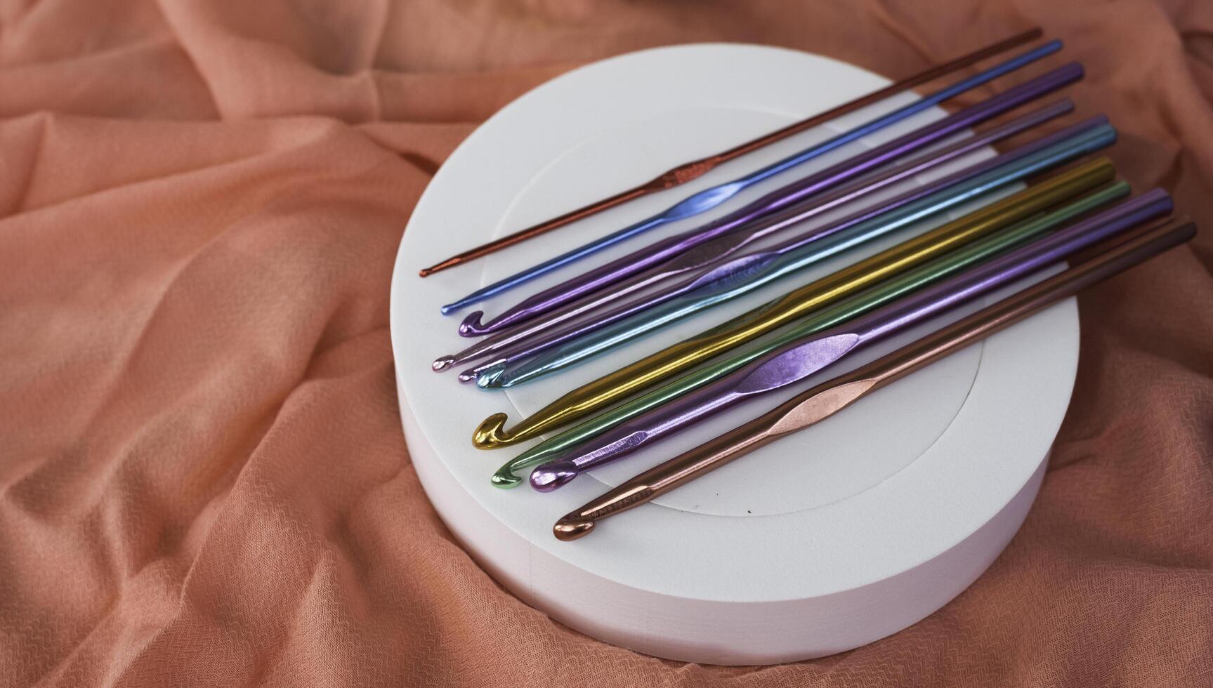 Metalic Crochet hooks put on background photo