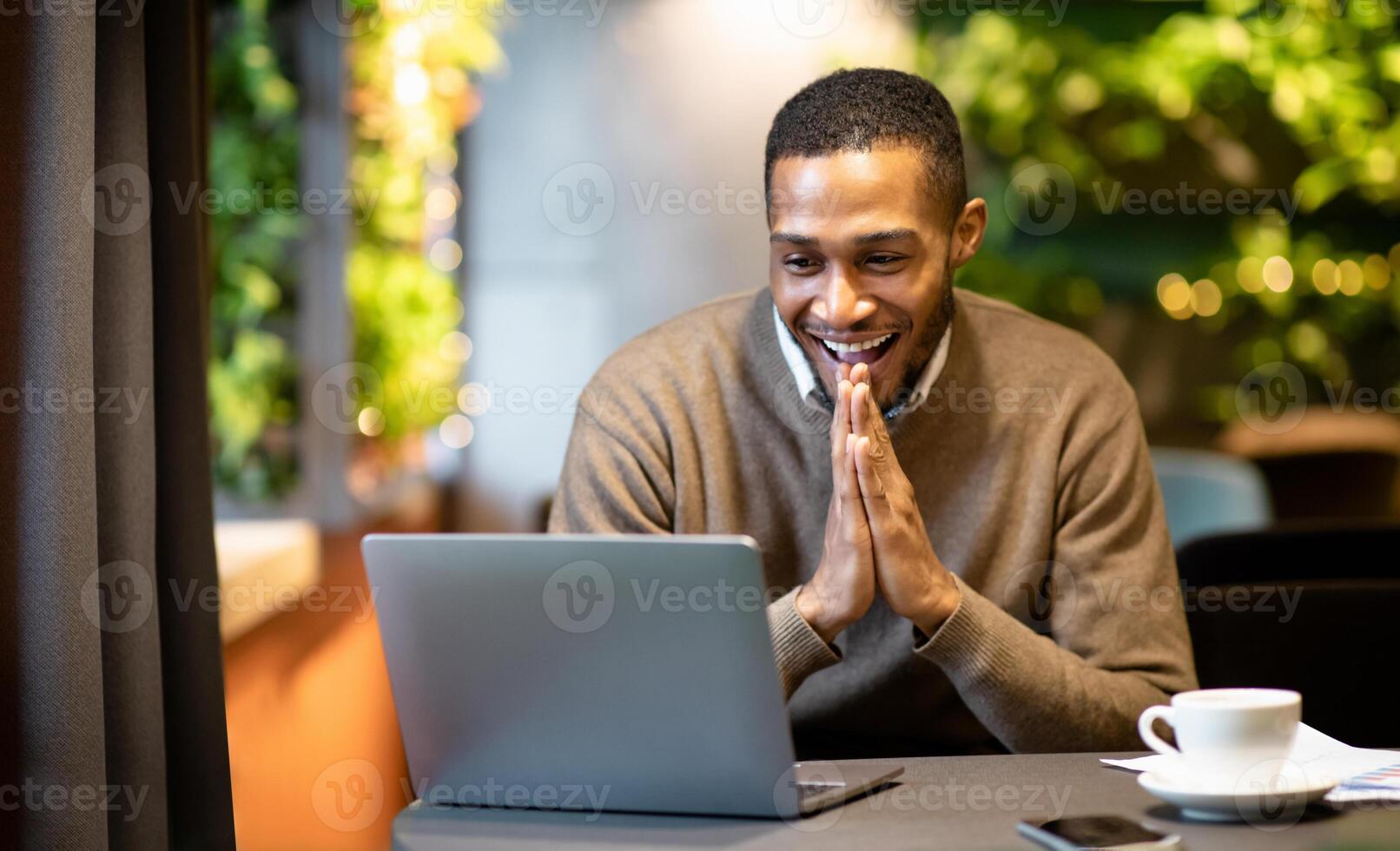 Luck And Win. Portrait of surprised young afro student looking at laptop computer, working at campus cafe, copyspace photo