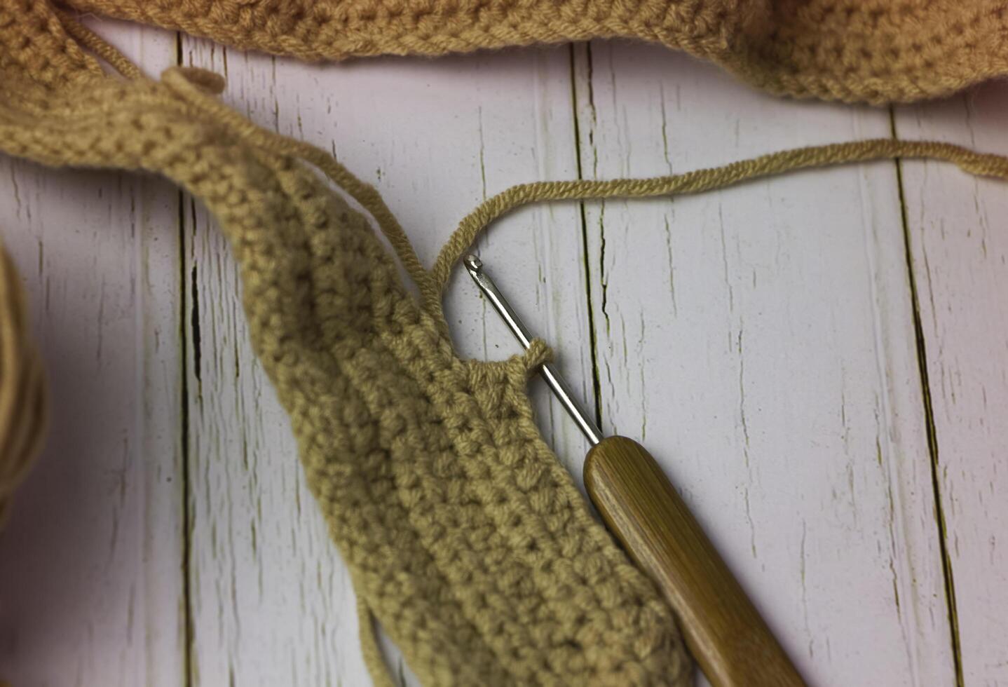 Head of crochet hook in cotton brown thread,knitting work photo