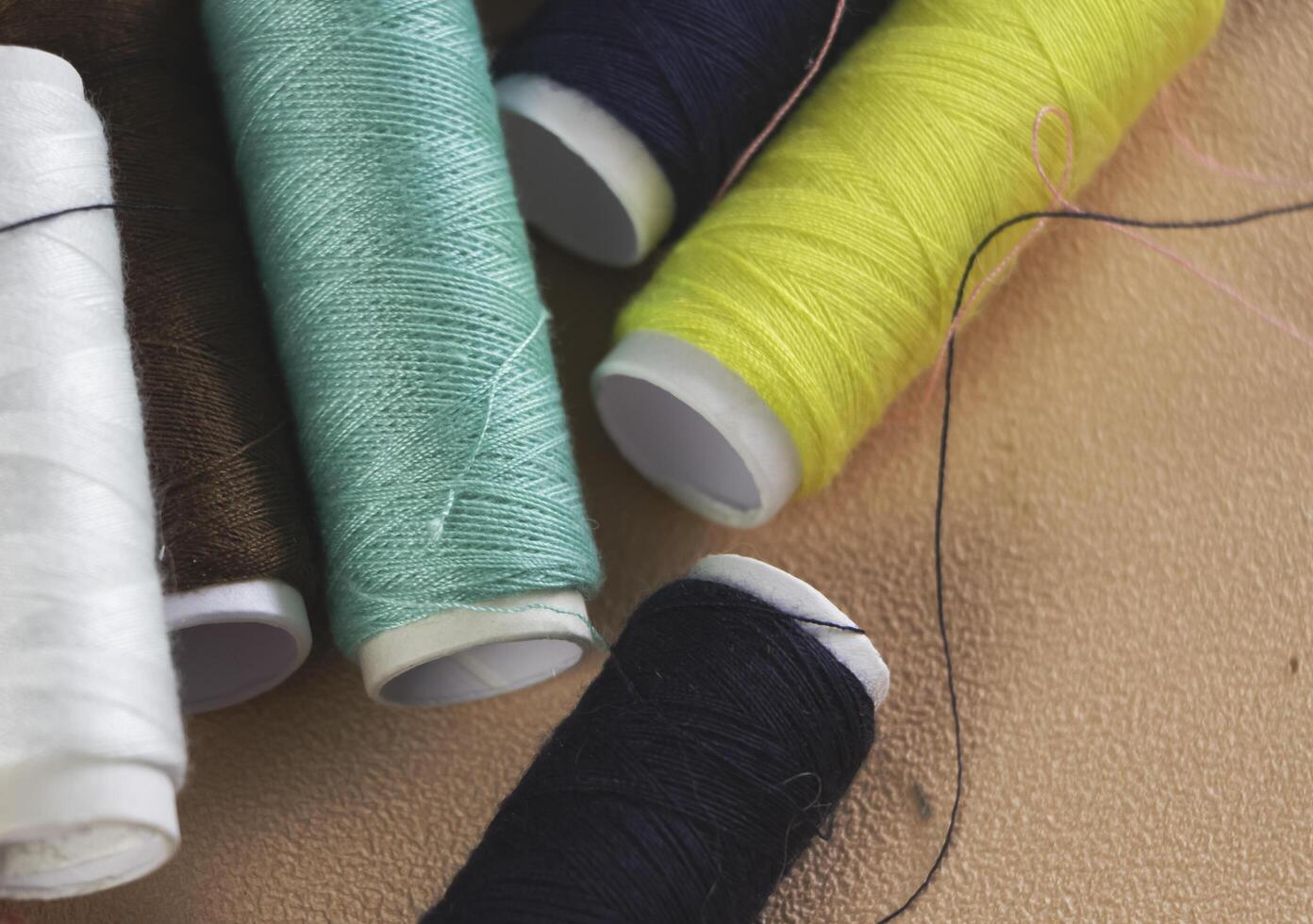 Colorful thread and needle work put on background photo