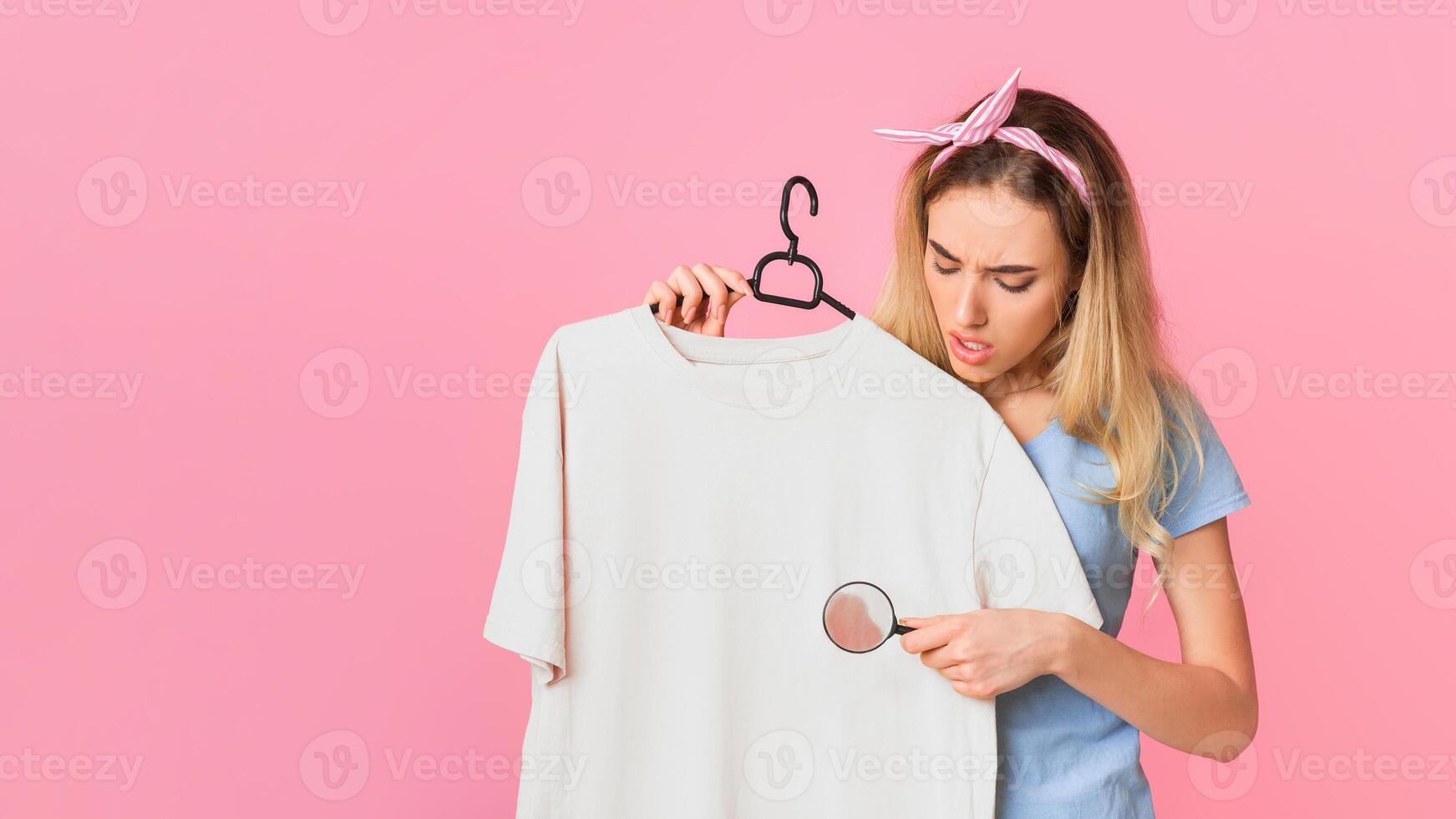 Find and remove stain on clothes. Housewife with magnifier, free space photo