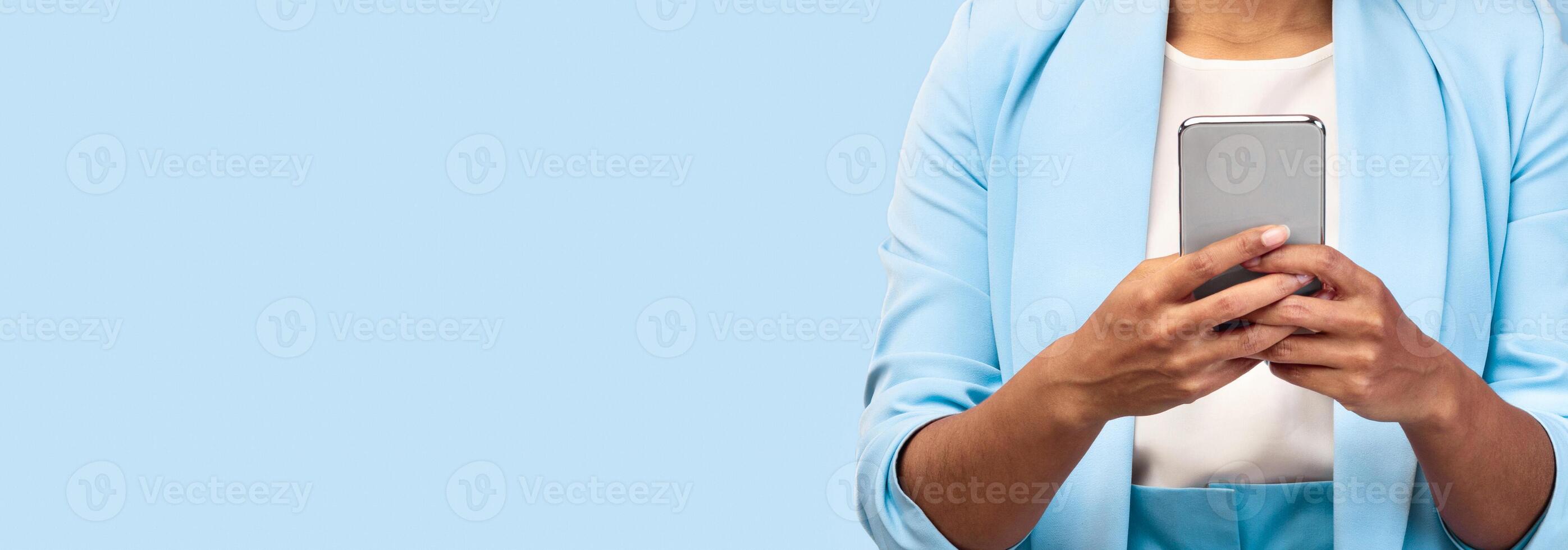 Cool Mobile App. Unrecognizable black girl using smartphone over pink wall. Panorama, copyspace photo