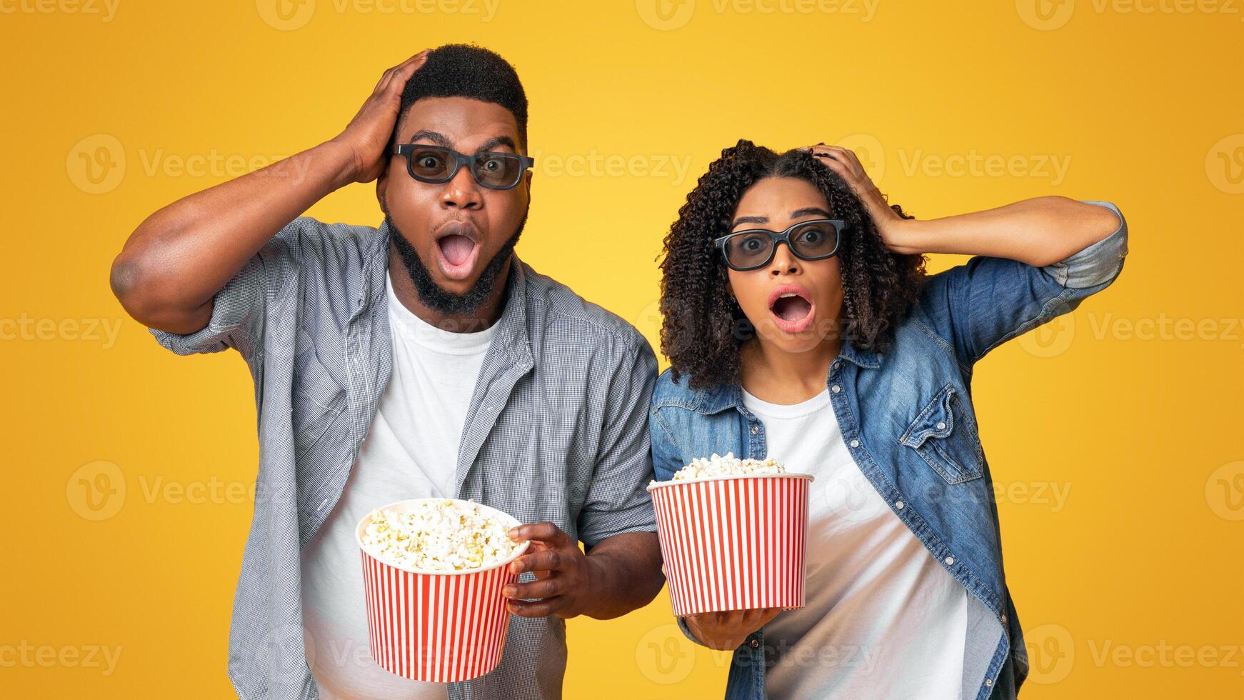 Amazing 3d Quality Movie. Shocked African Couple Holding Popcorn And Looking At Camera With Open Mouth photo
