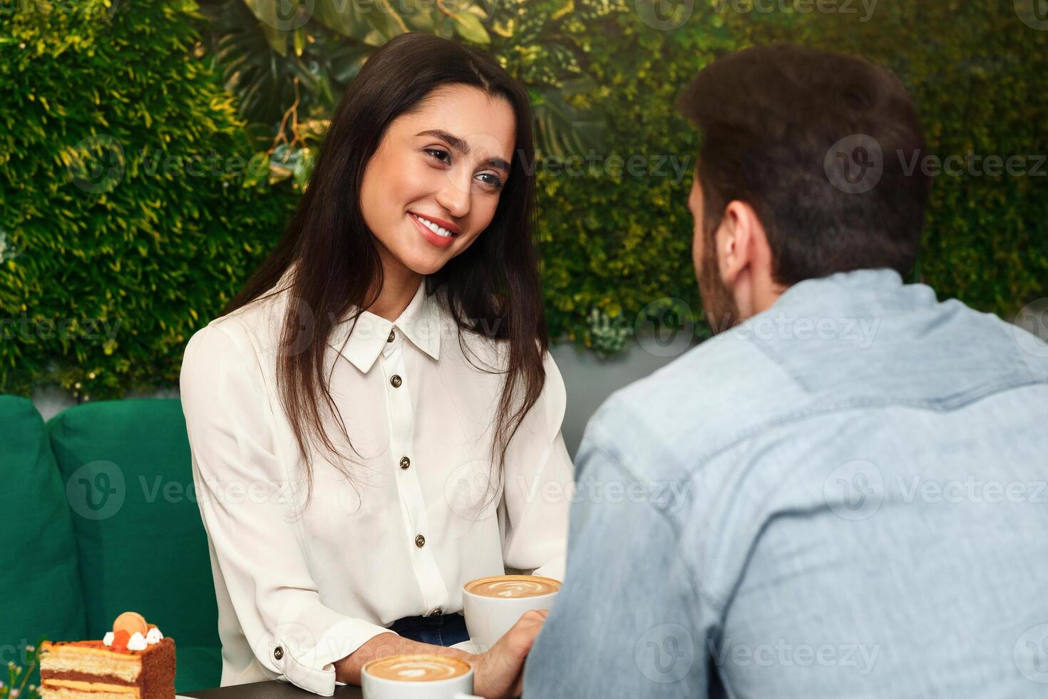 First Date. Girlfriend Smiling Flirting With Boyfriend On Romantic Date In Cafe. Selective Focus photo