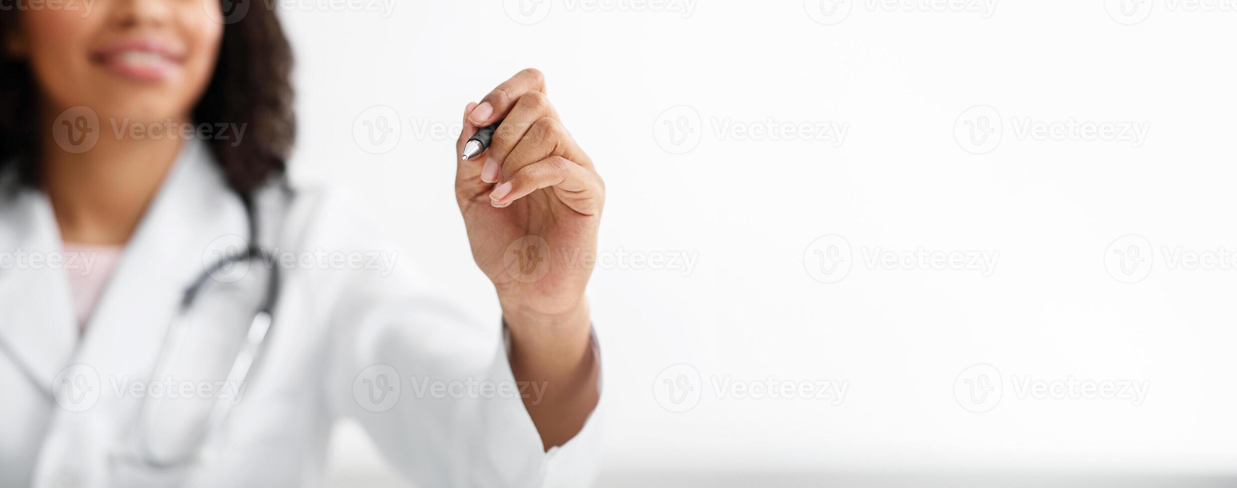 Cropped of african american female doctor drawing something on copy space, using pan, white background photo