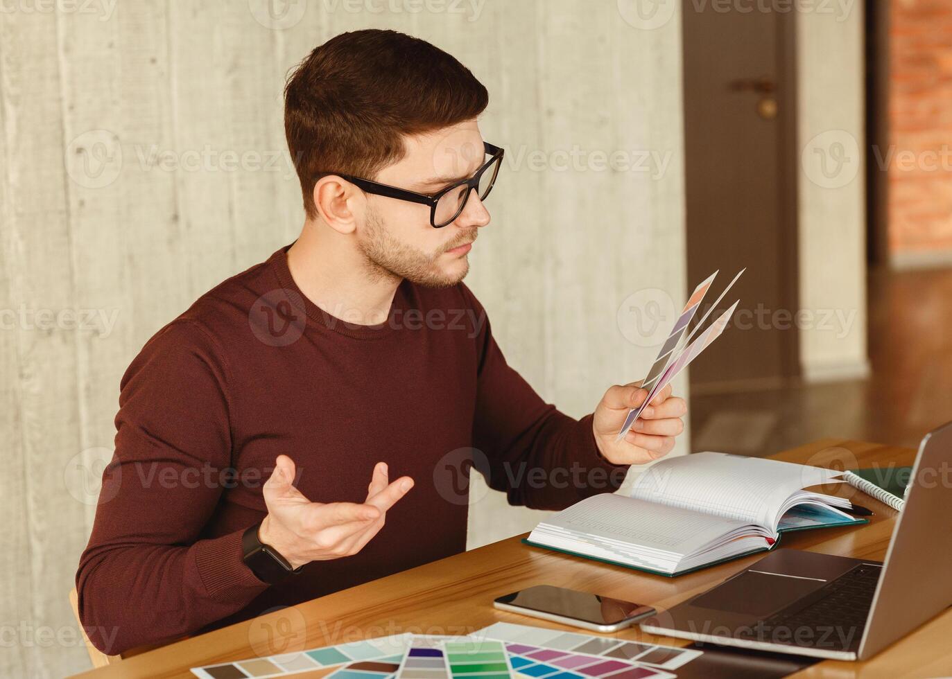 Freelancer Designer Man Working With Color Samples Sitting In Modern Office. Creative Design Job. Selective Focus photo