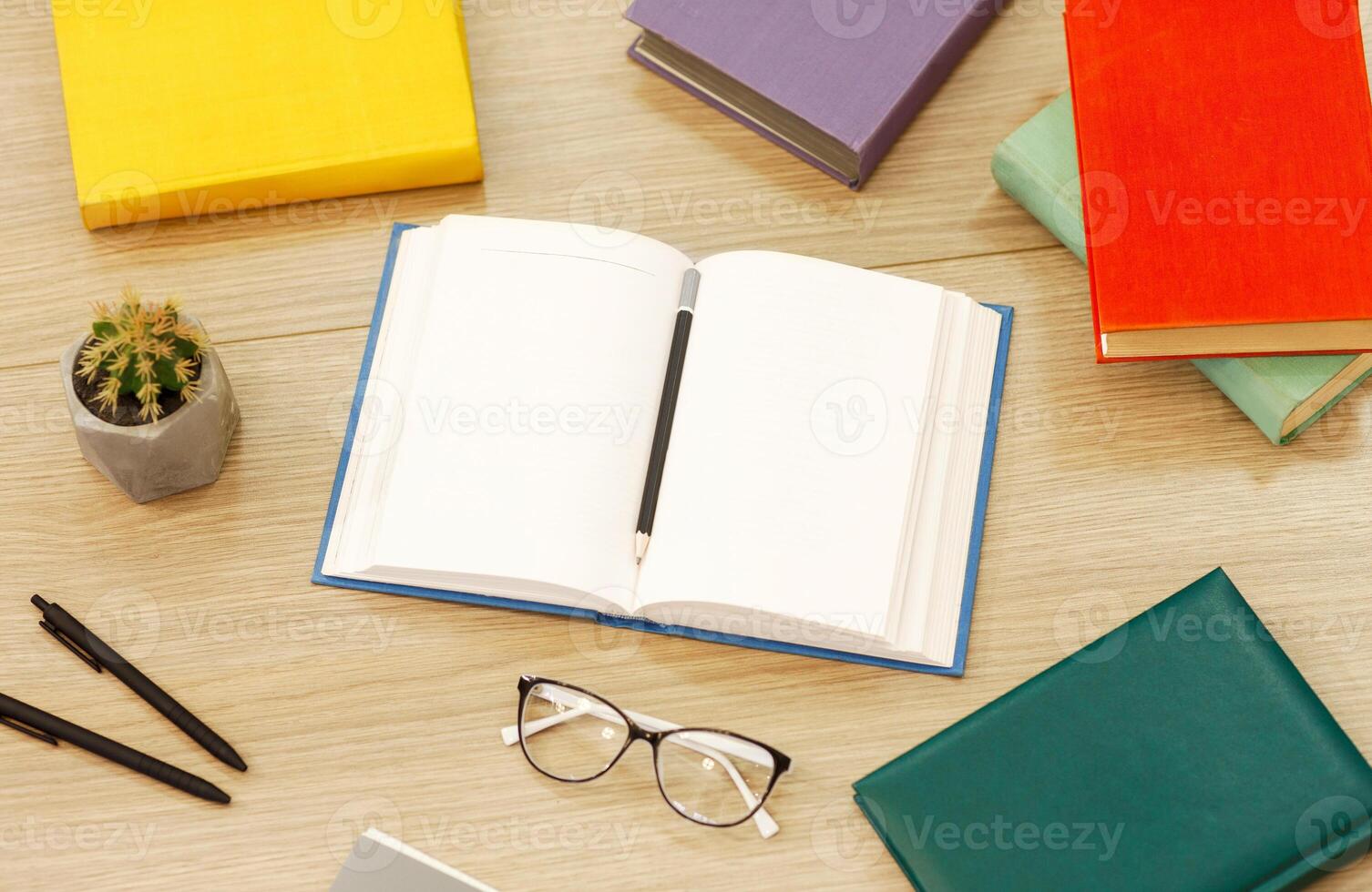 Time To Study. Above view arrangement of educational books on the wooden desk, open notebook with pencil, flat lay photo
