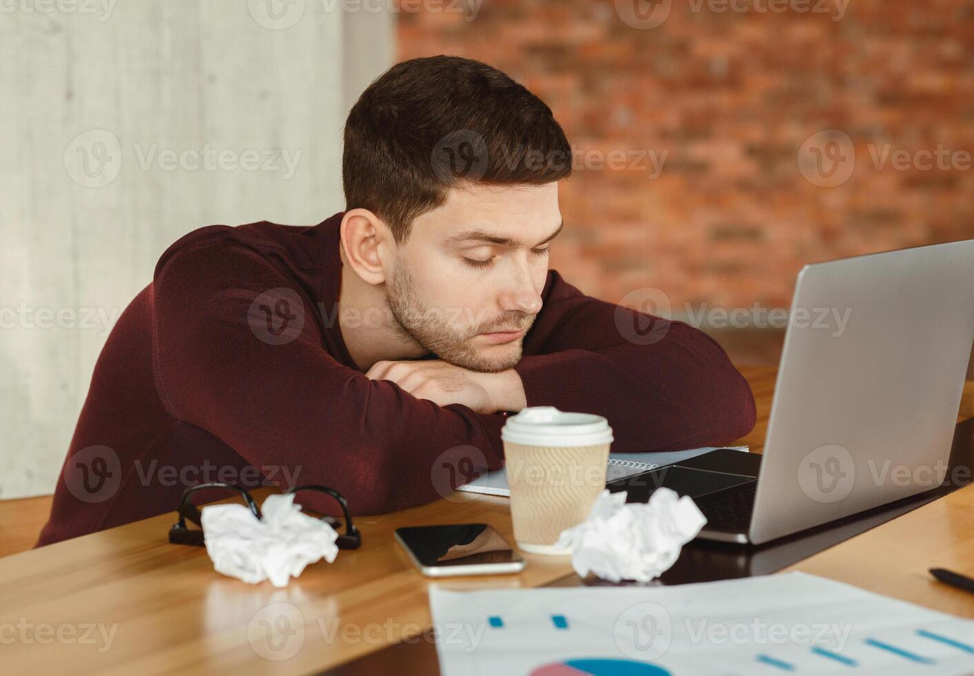 Nap At Work. Tired Office Guy Sleeping Sitting At Laptop At Workplace Indoor. Selective Focus photo