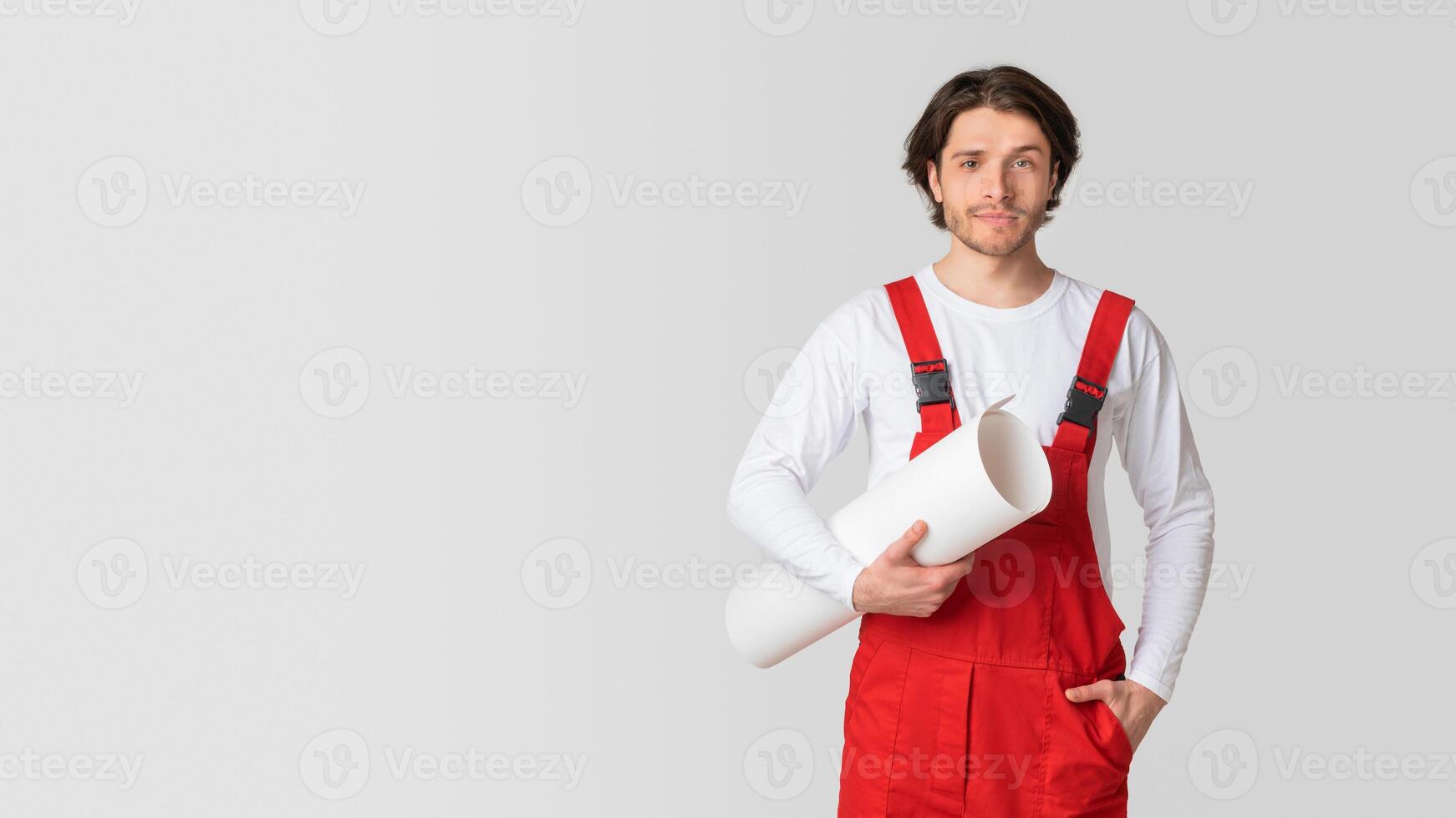 Construction Industry Employee. Portrait Of Young Engineer With Renovation Plan Draft Posing On White Background In Studio, Panorama With Copy Space photo