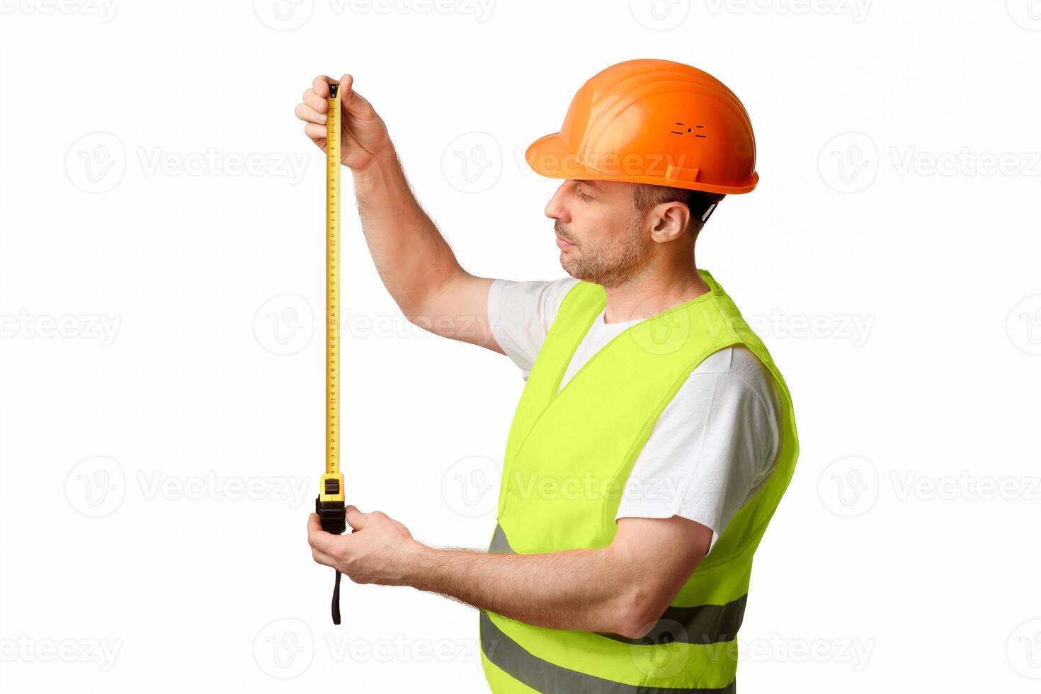 Building Engineer Worker Holding Tape-Measure Posing Standing Over White Background In Studio. Construction Regulations Concept. photo