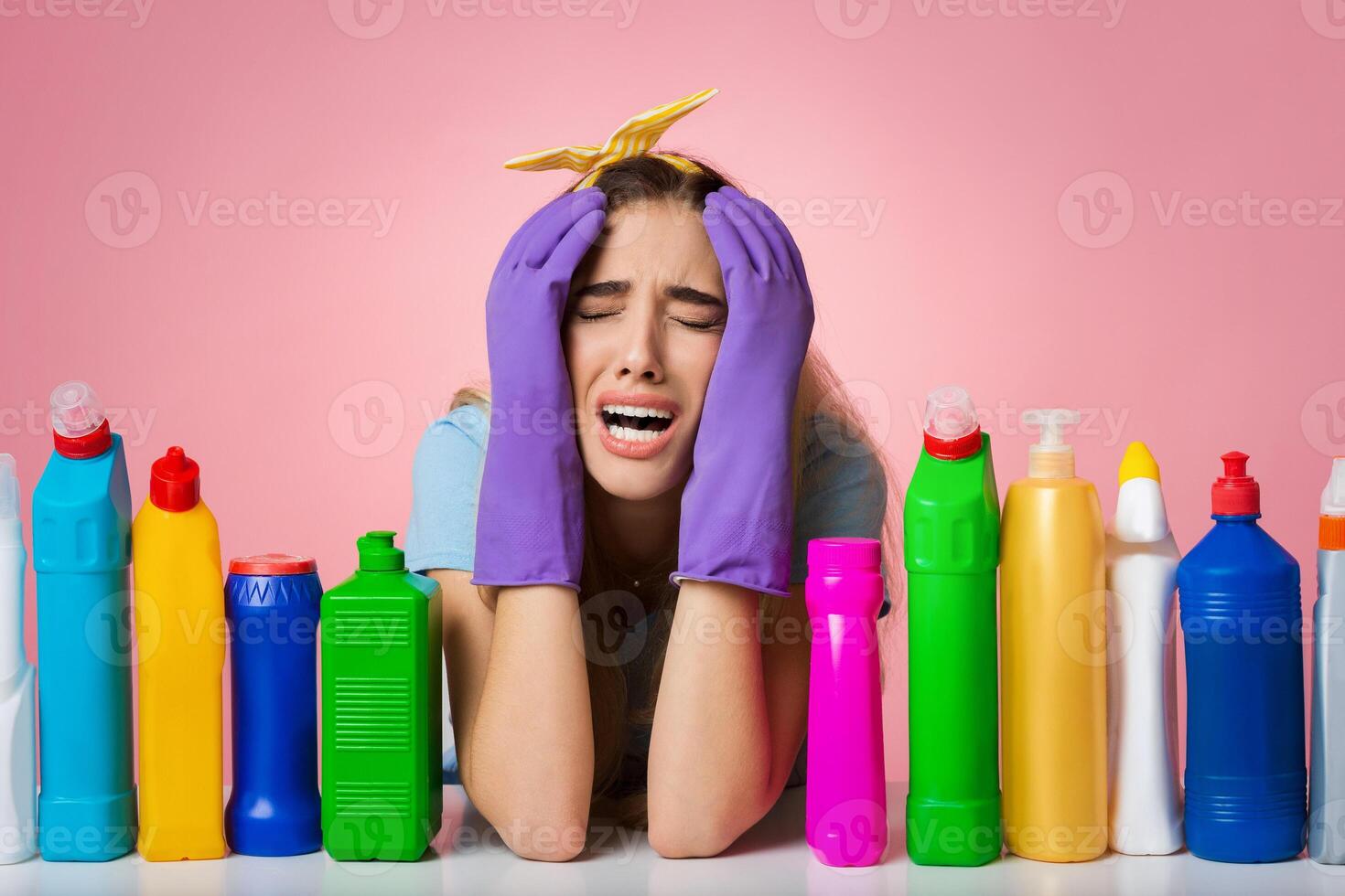Young housewife crying by cleaning, near cleaning supplies, panorama, free space photo