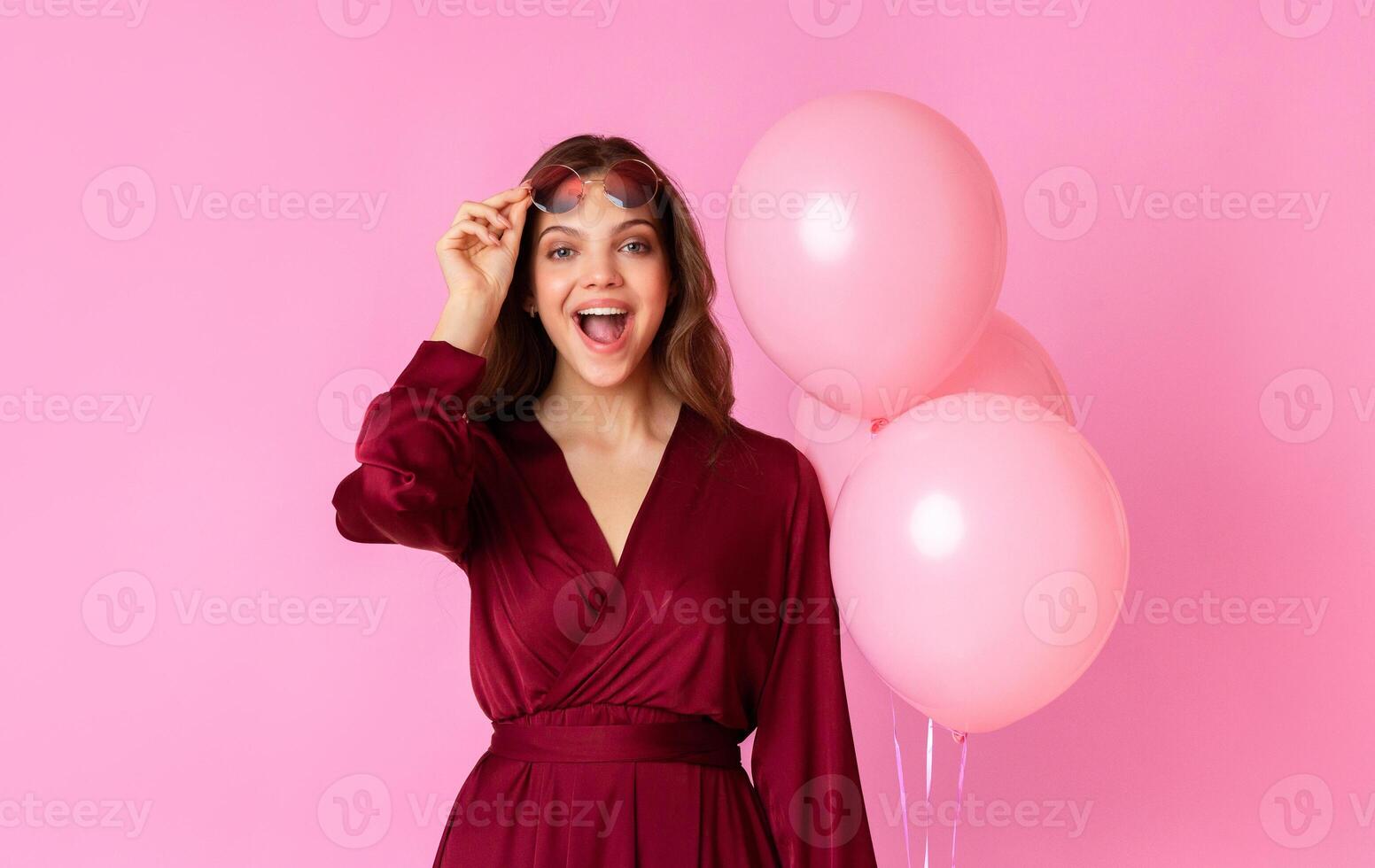 Wow. Surprised Lady Taking Off Glasses And Opening Mouth In Amazement, Holding Balloons While Posing Over Colorful Background, Free Space photo