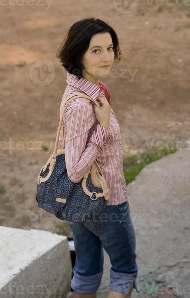 pretty brunet woman with bag photo