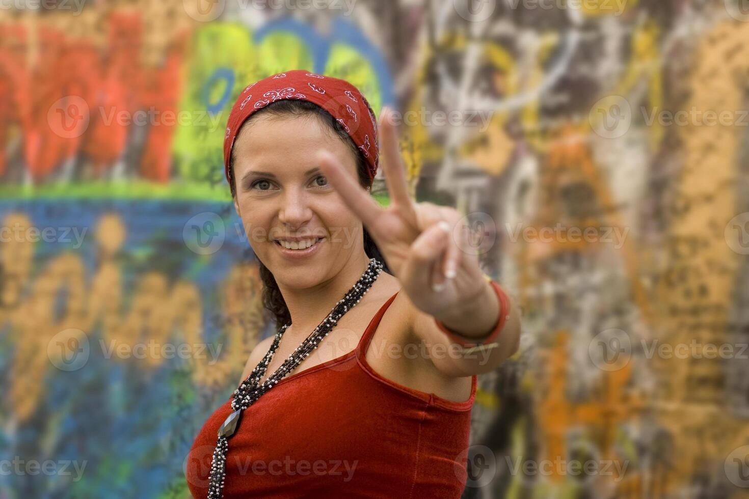 woman making victory gesture photo