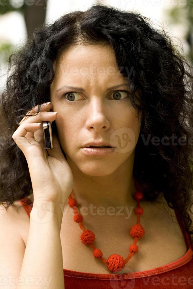 woman on phone getting bad news photo