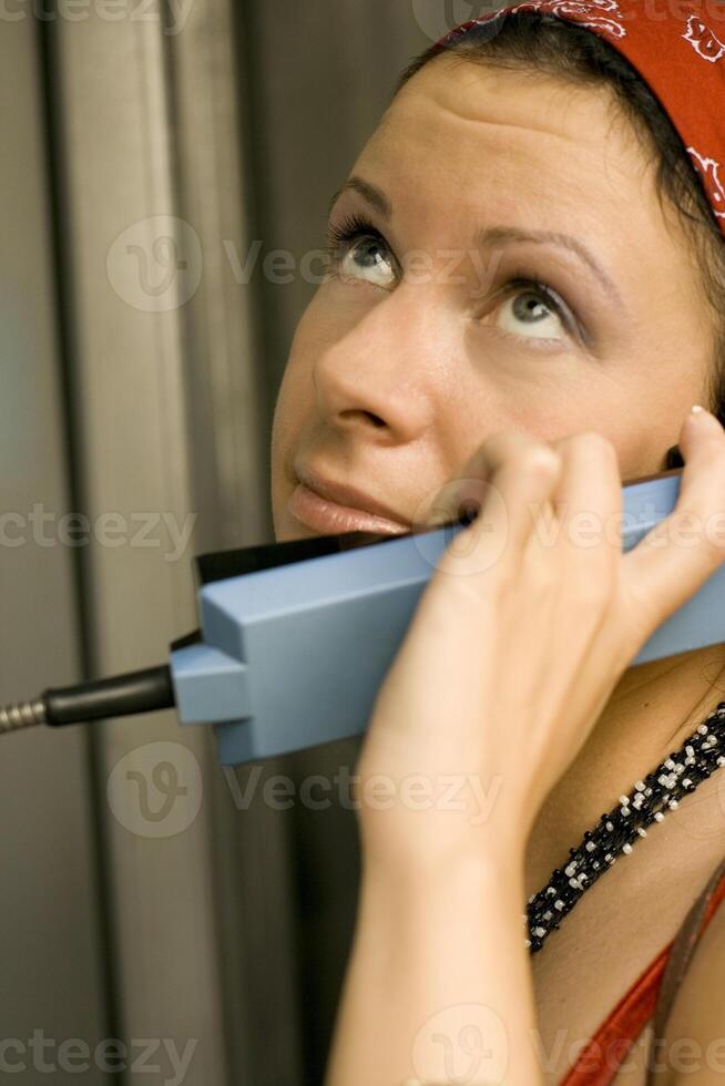 girl having a call on a telephone photo