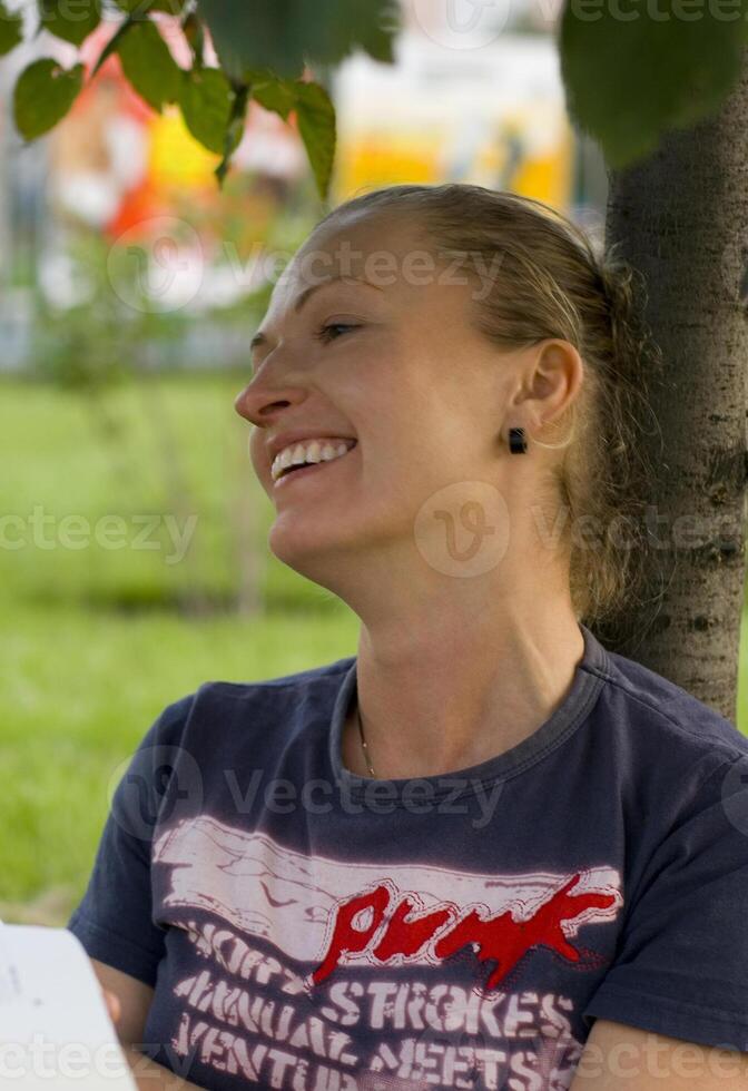 laughing woman under the tree photo