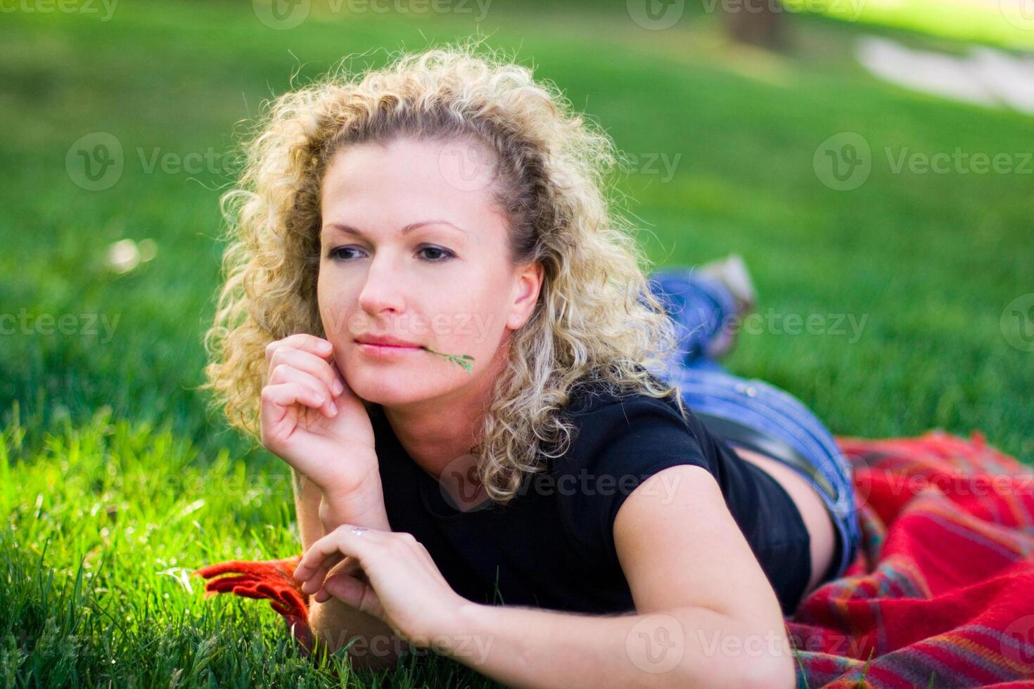 woman lying on green grass photo