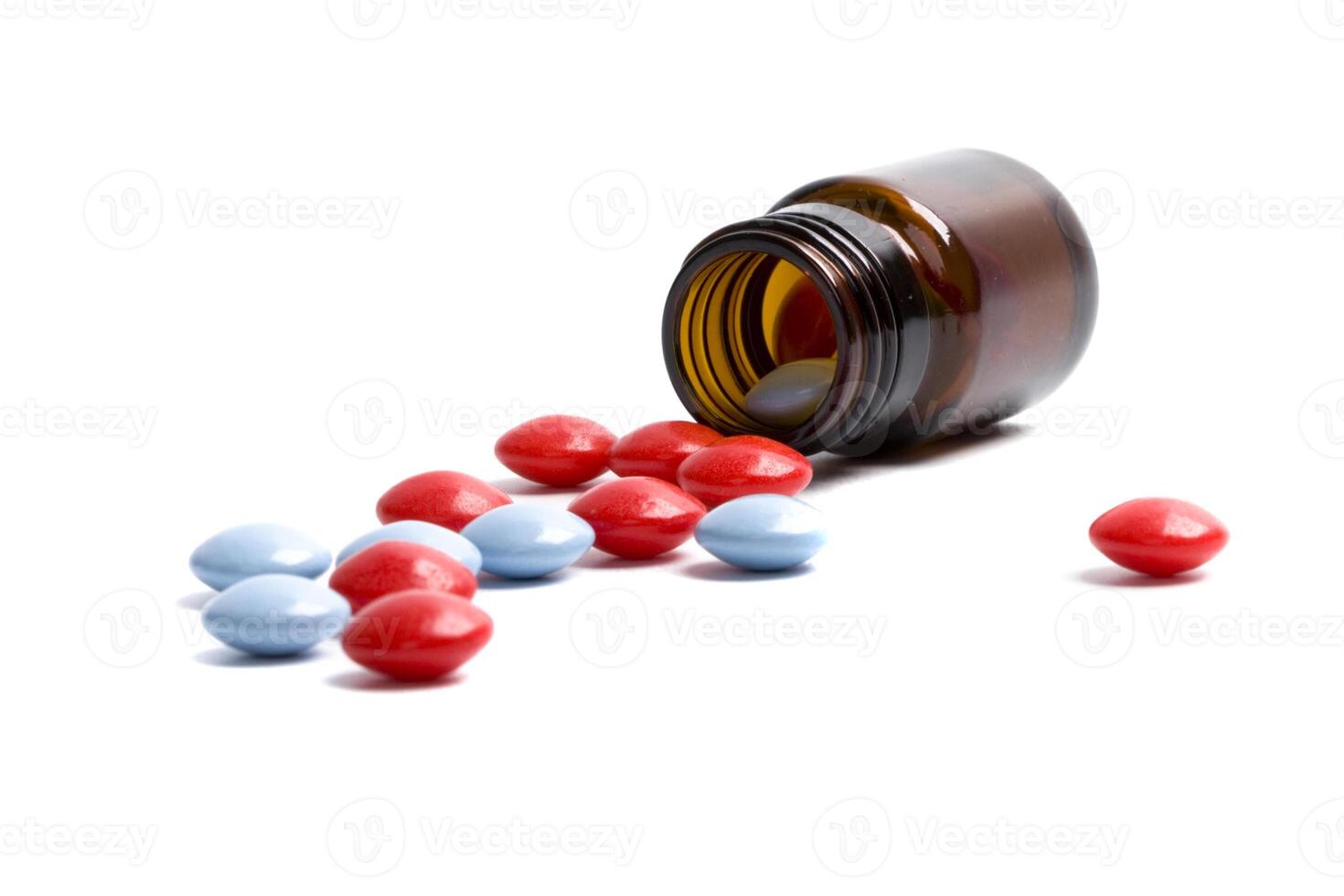glass bottle with red and blue pills photo