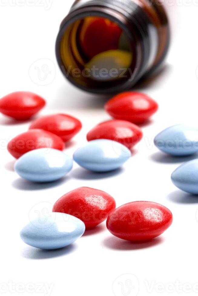 bottle with red and blue pills photo