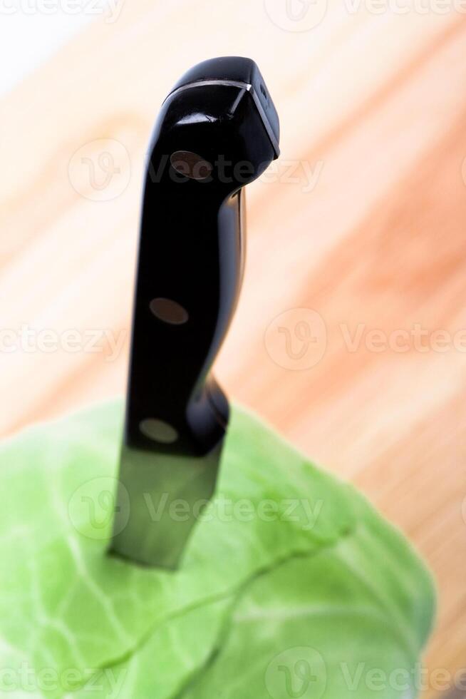 green cabbage with knife photo