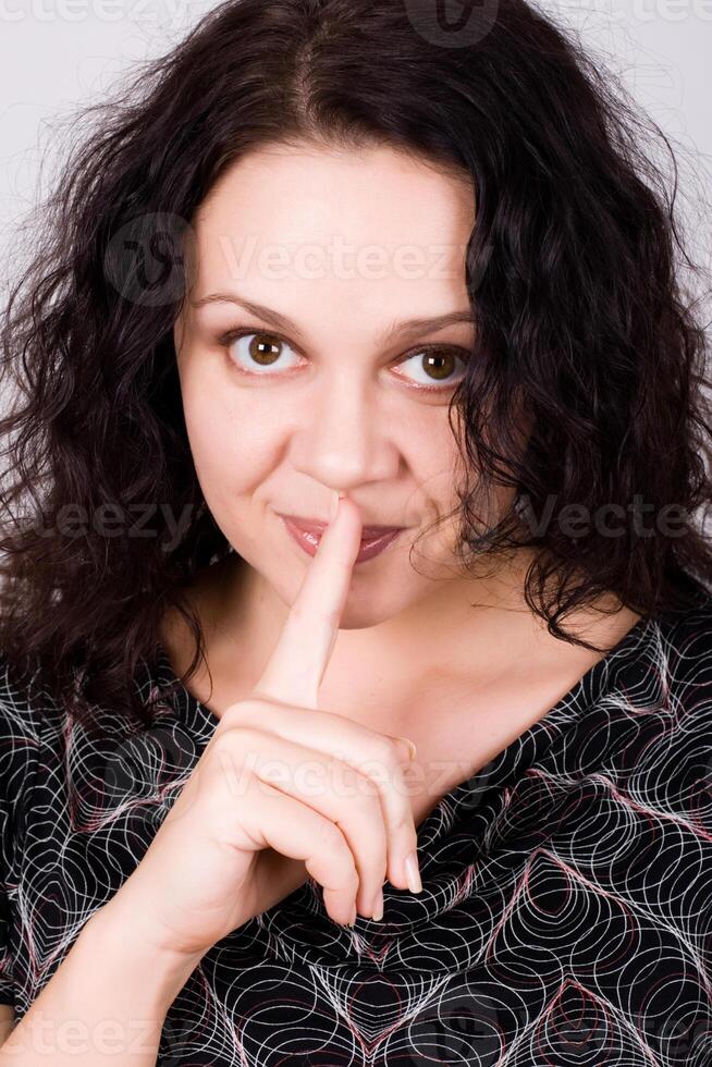 woman with finger on lips photo