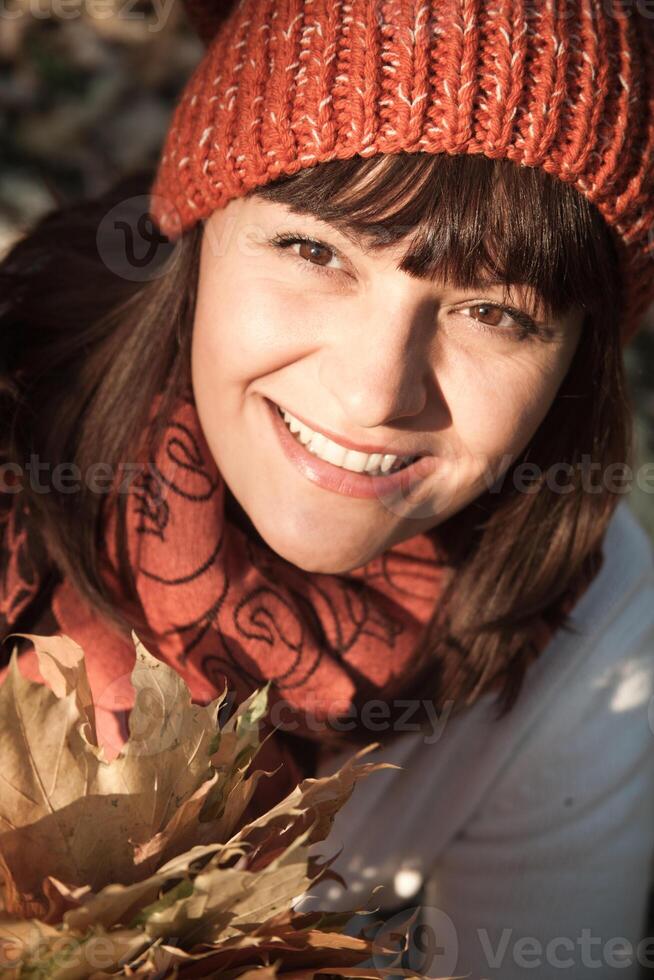 woman with autumn orange leaves photo