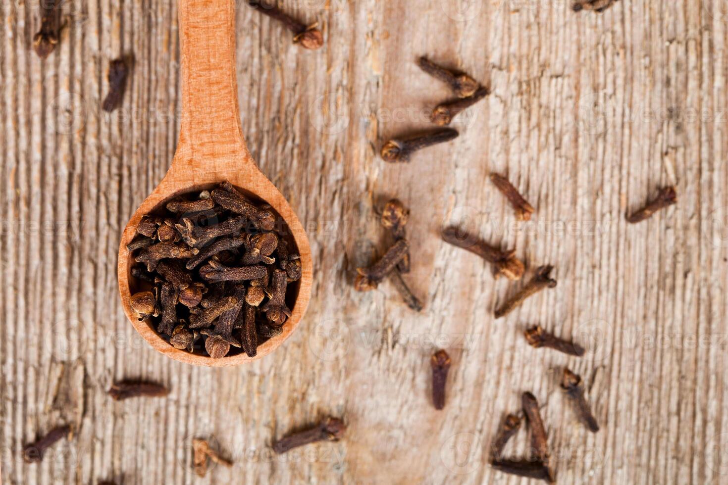 cloves in wooden spoon photo