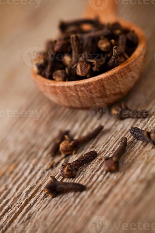 cloves in wooden spoon photo