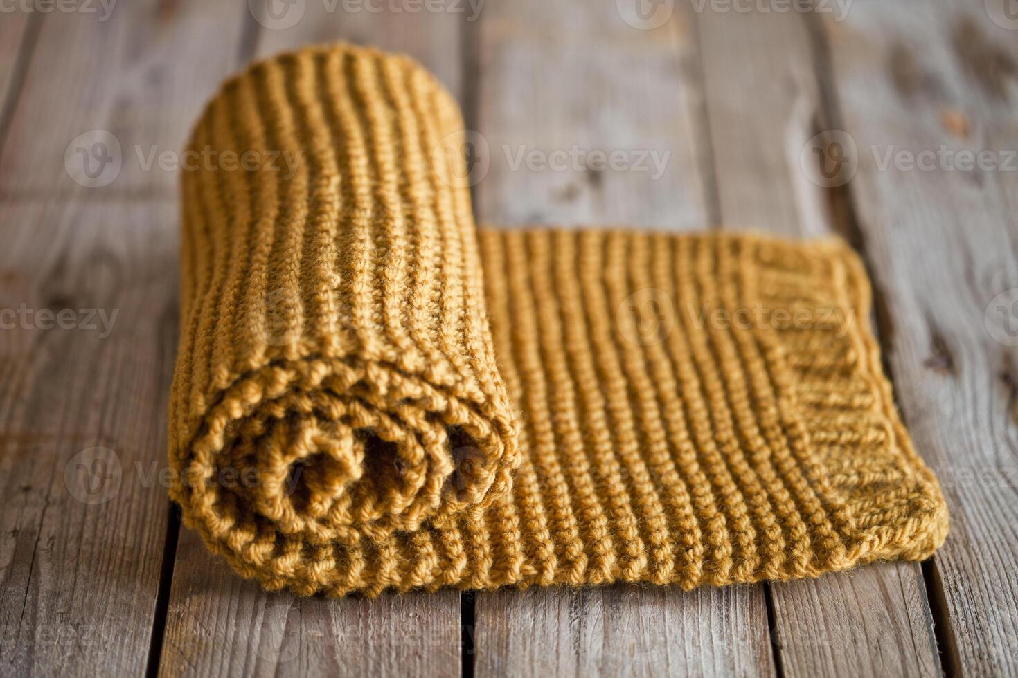 Hand knitted yellow scarf. photo