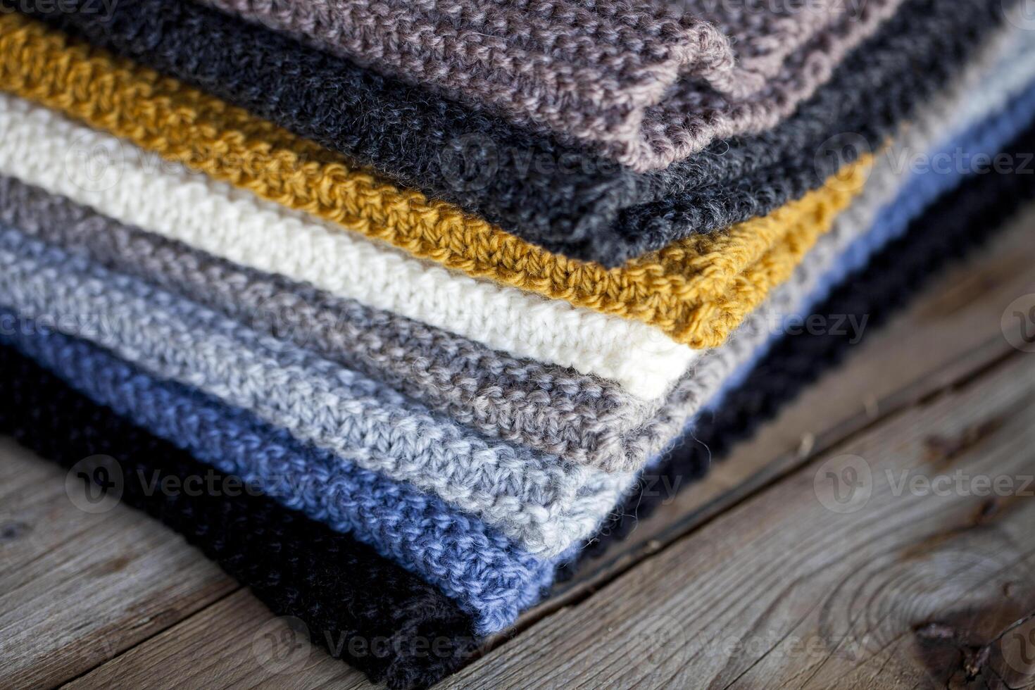 Heap of hand knitted wooden scarves. photo