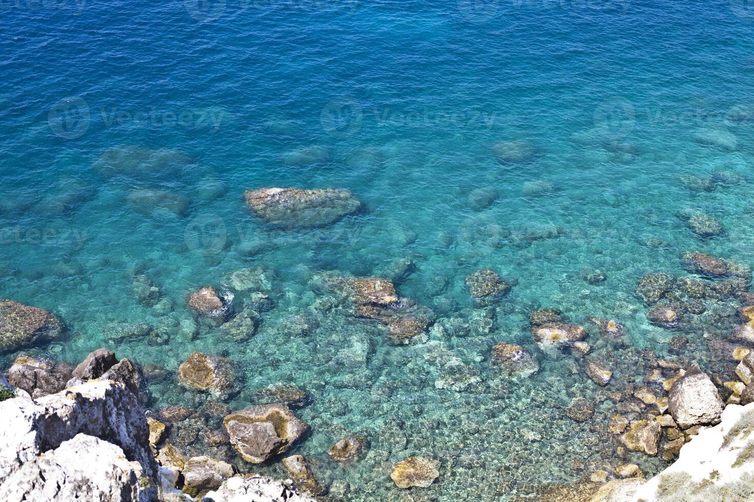 Aerial view of rocks on the sea. Overview of the seabed seen from above, transparent water photo