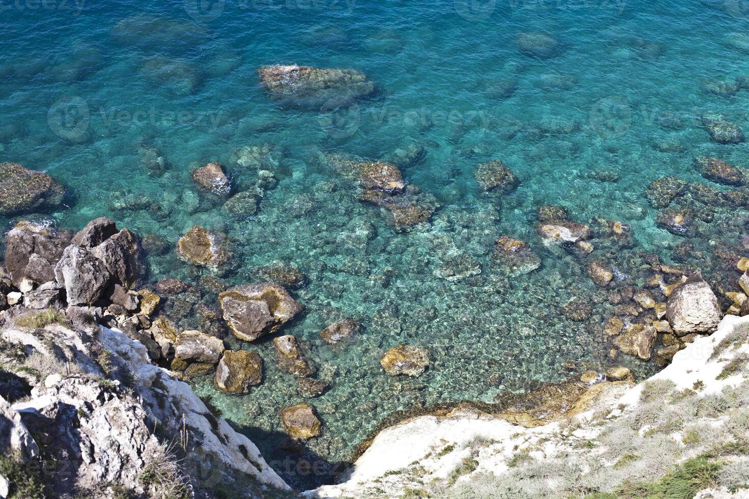 Aerial view of rocks on the sea. Overview of the seabed seen from above, transparent water photo