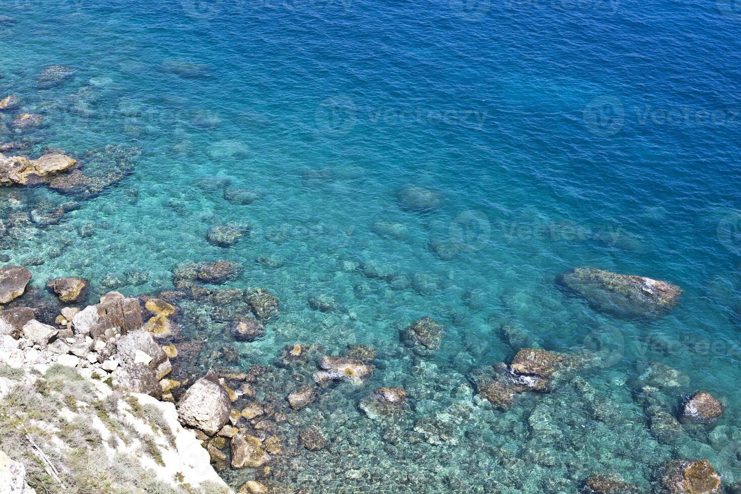 Aerial view of rocks on the sea. Overview of the seabed seen from above, transparent water photo